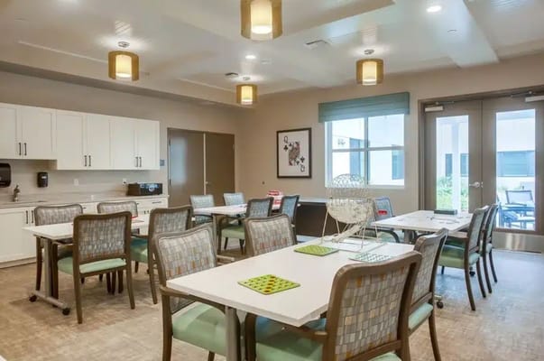 Bright dining room with tables and chairs at Westmont of Encinitas