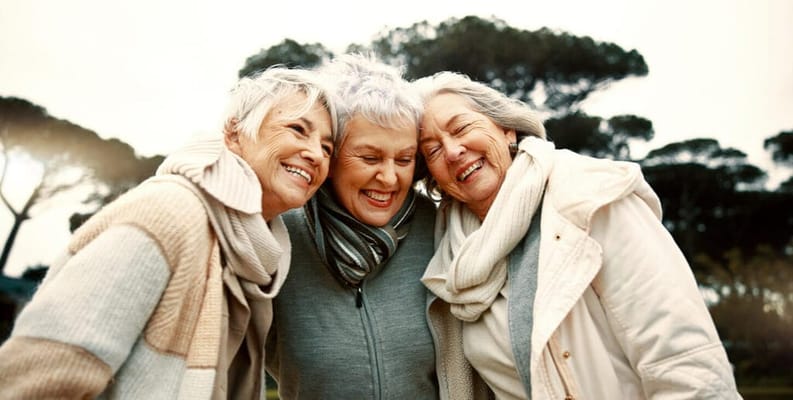 Three smiling senior women enjoying time outdoors