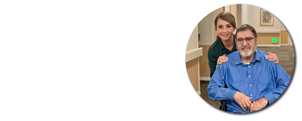 Staff member posing with resident in a common area