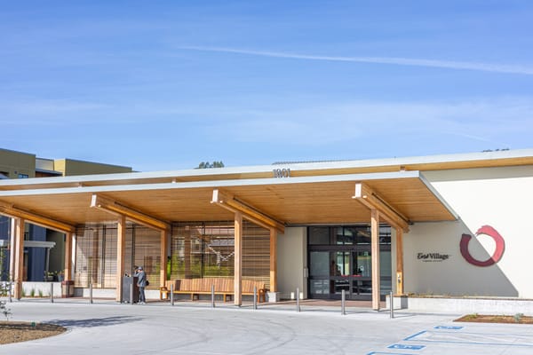 Entrance of Enso Village with staff and residents