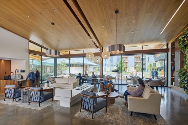 Shared lounge area with residents and staff interacting