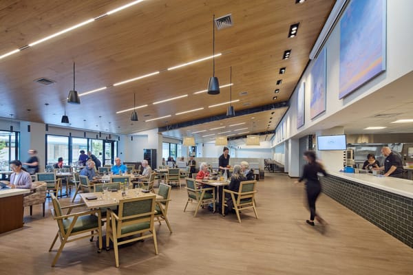 Residents and staff enjoying a meal in a dining area