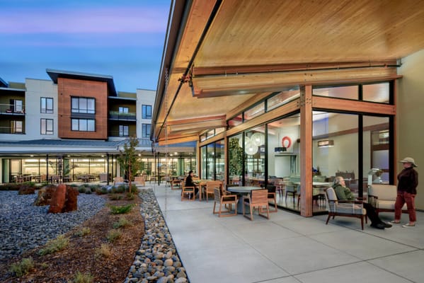 Outdoor seating area with residents enjoying the weather