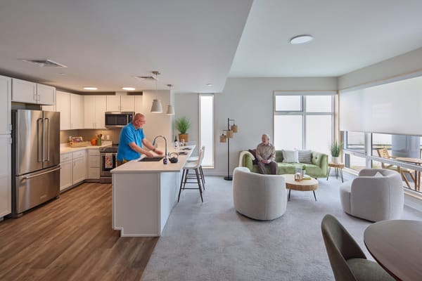Residents enjoying a bright common area in the facility