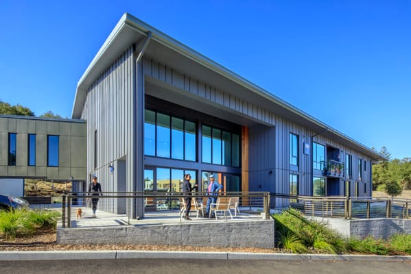 Modern assisted living facility exterior with people