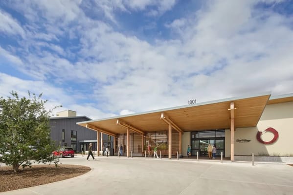 Front entrance of Enso Village with residents and outdoor space