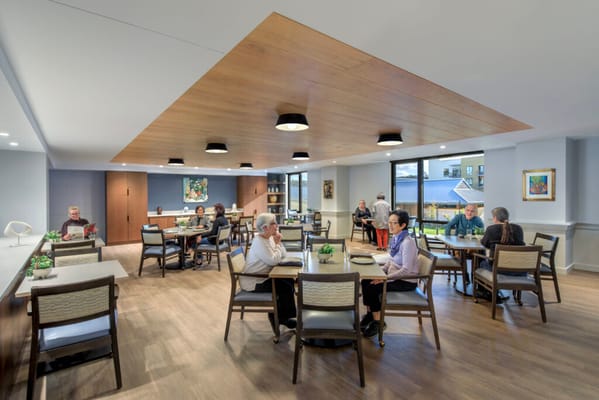 Residents dining in a bright and modern dining room