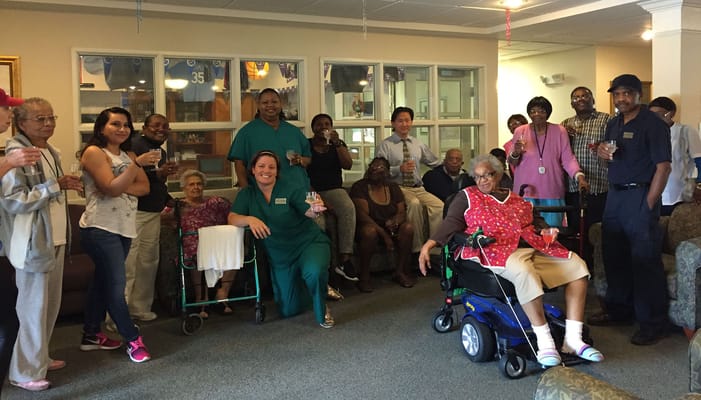 Residents and staff celebrating in a common area