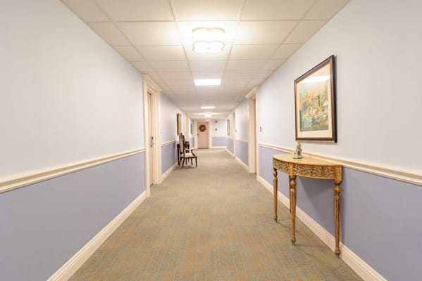 A hallway with seating and artwork in a facility