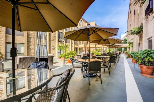 Outdoor patio area with tables and umbrellas