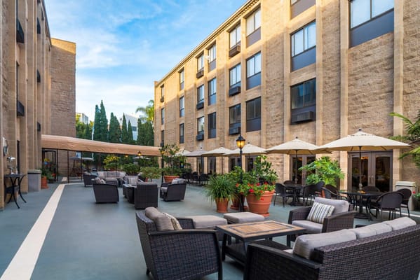 Outdoor seating area with umbrellas and plants