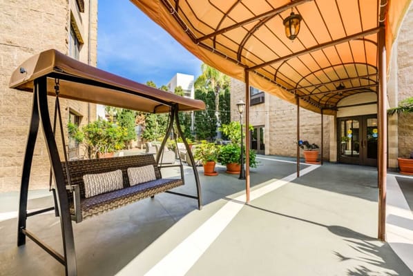 Covered swing in a welcoming outdoor area of the facility