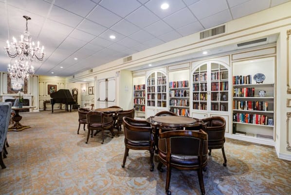 A beautifully designed common area with bookshelves and seating