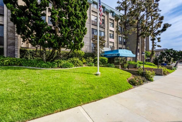 Building exterior with manicured landscaping and entrance awning