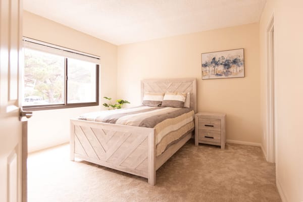 A bright, cozy resident bedroom with modern furnishings