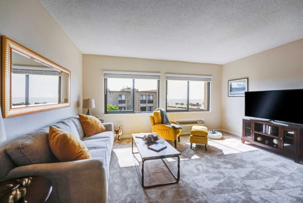 Cozy living room with large windows and ocean view