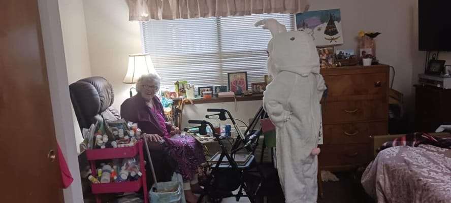 Resident enjoying a visit from a person in a bunny costume