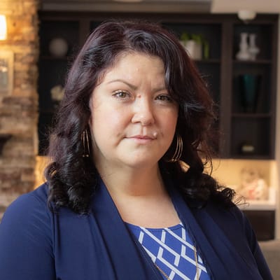 Staff member in a warm lobby setting