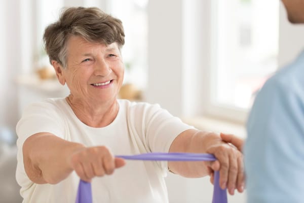 A smiling resident participating in a therapy session
