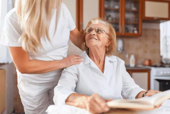 Caregiver interacting with a resident in a cozy interior