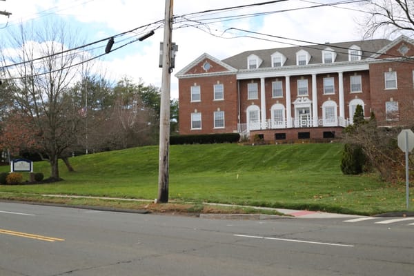 Exterior view of a senior living facility with landscaping