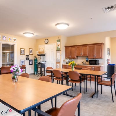 Bright common area with tables and flowers