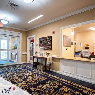 Welcoming reception area with a decorated wall and front desk