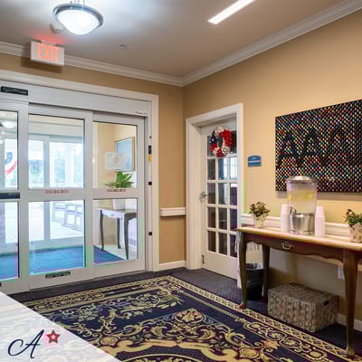 Bright common area with seating and beverage station