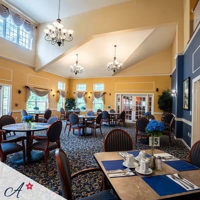 Bright dining room with tables set for a meal