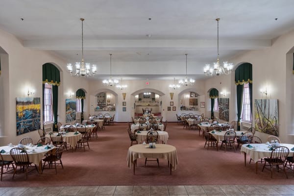 Dining room with tables set for residents