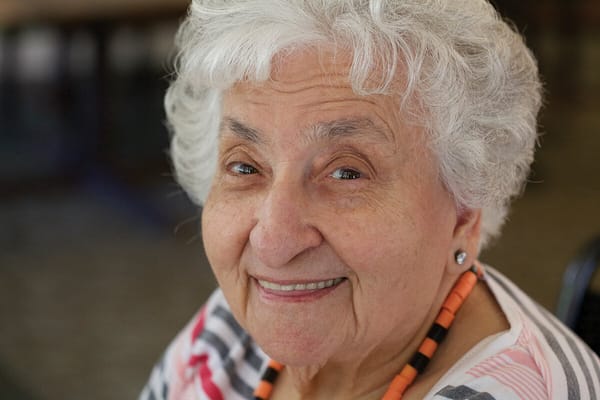Smiling elderly woman with curly white hair