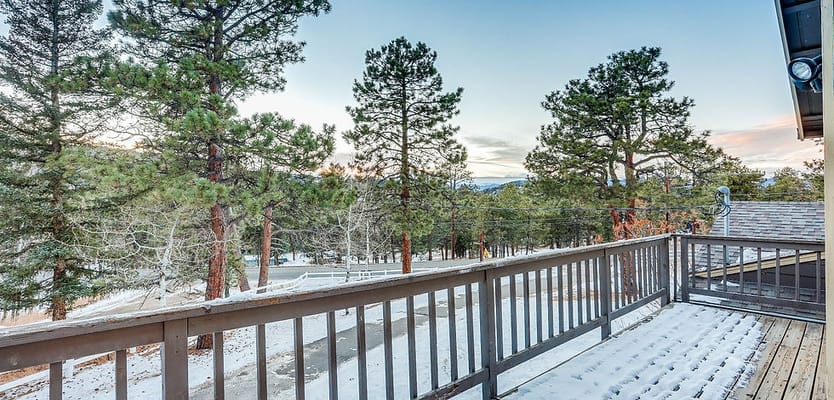 View from a deck overlooking a forested area