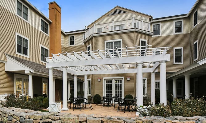 Outdoor terrace area with a pergola and seating