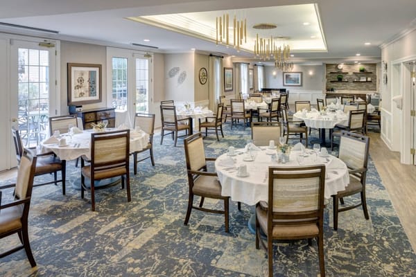 Dining room set up for meal service with tables and chairs