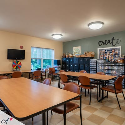 Bright activity room with tables and chairs