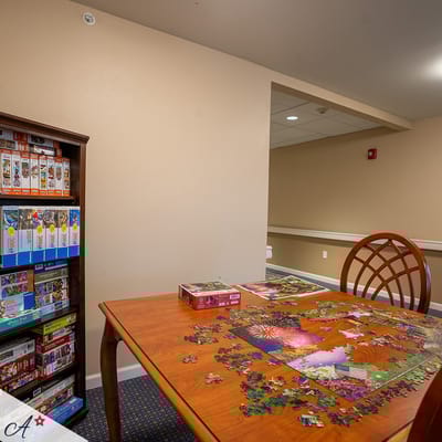 Table with a jigsaw puzzle and game boxes