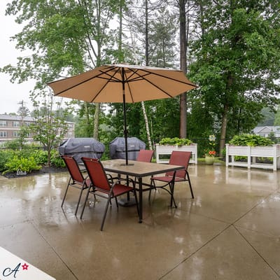Covered patio area with seating and umbrellas