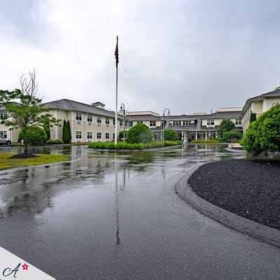 Exterior view of a nursing home facility on a rainy day