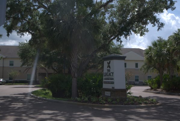Exterior view of The Legacy at Highwoods Preserve facility sign