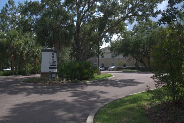 Entrance of The Legacy at Highwoods Preserve with landscaping