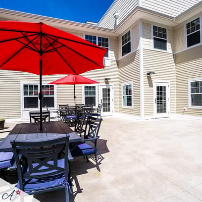 Outdoor seating area with red umbrellas and tables