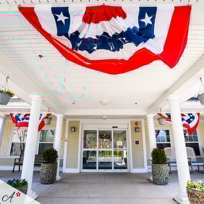 Entrance of the facility decorated with red, white, and blue bunting