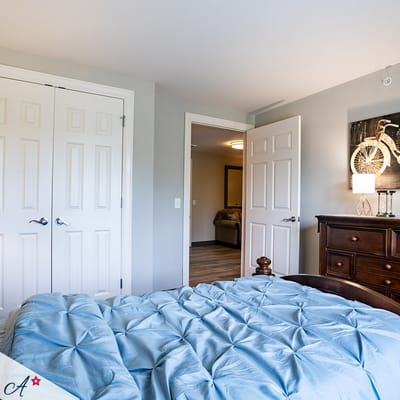 A private resident room with a blue bedspread