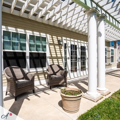 Outdoor seating area with wicker chairs and a flower pot