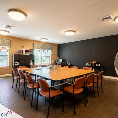 Bright and inviting activity room setup with chairs and a table