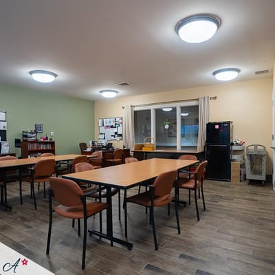 Interior view of a common area with tables and chairs