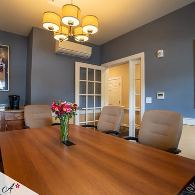 Bright meeting room with a table and flower arrangement
