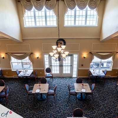 Dining area with tables and chairs in bright space