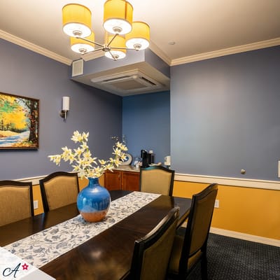 Dining area with a table set and floral centerpiece