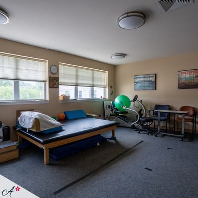 Physical therapy room with equipment and seating